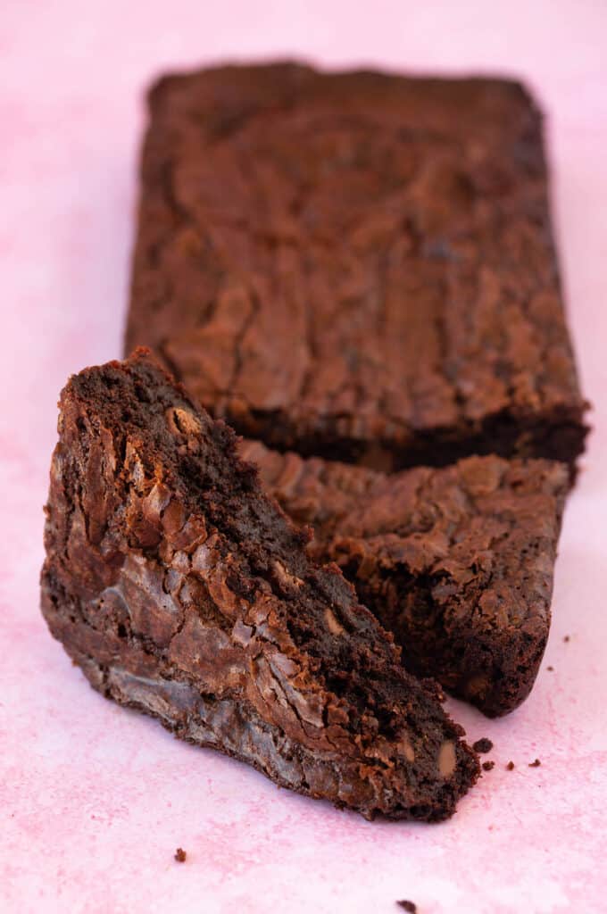 Delicious homemade brownies on a pink background.