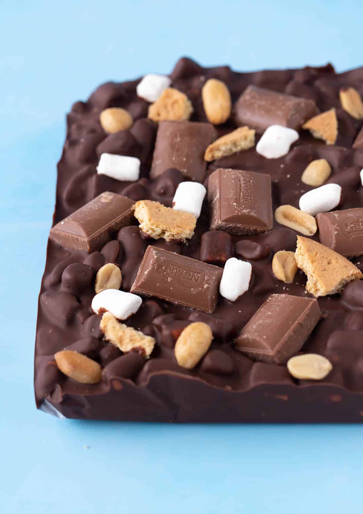 A slab of homemade Smores Rocky Road on a blue background