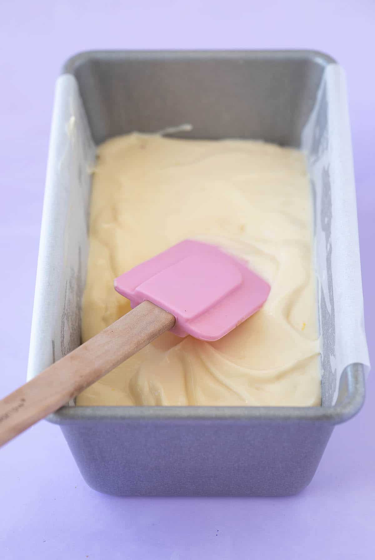 A small baking pan filled with creamy cheesecake batter