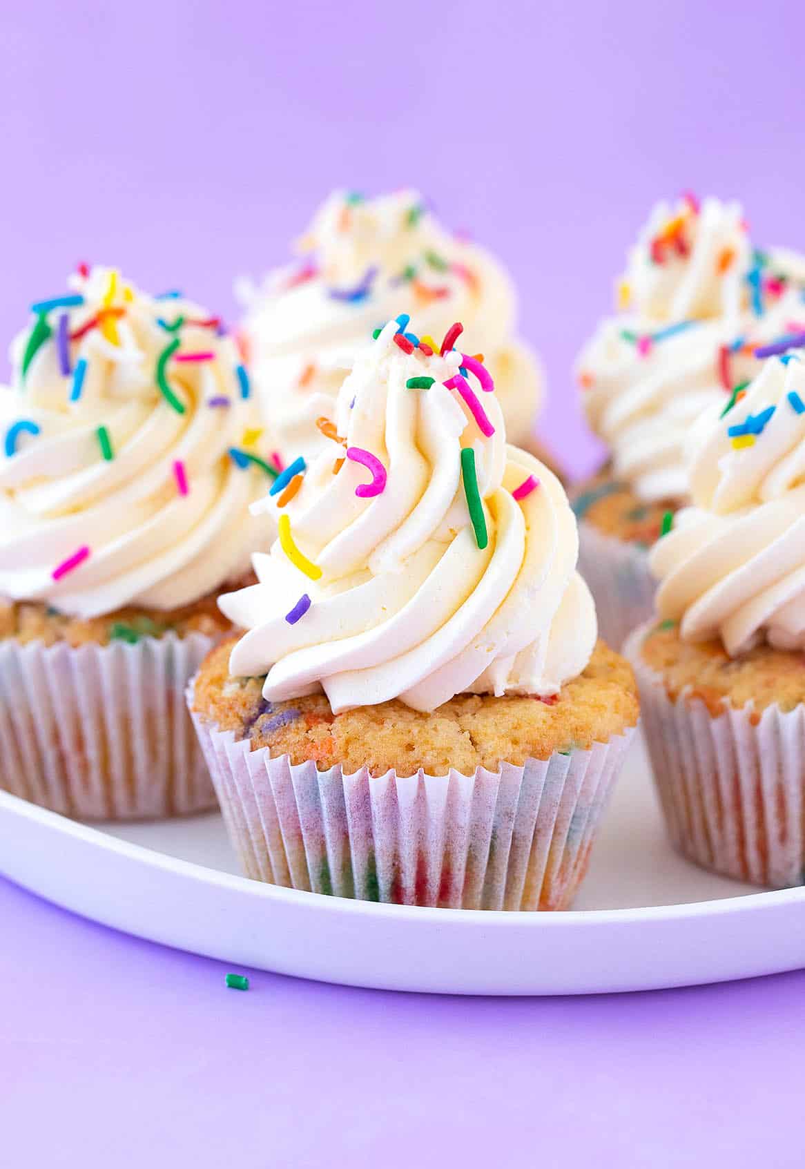 A white plate filled with Funfetti Cupcakes.