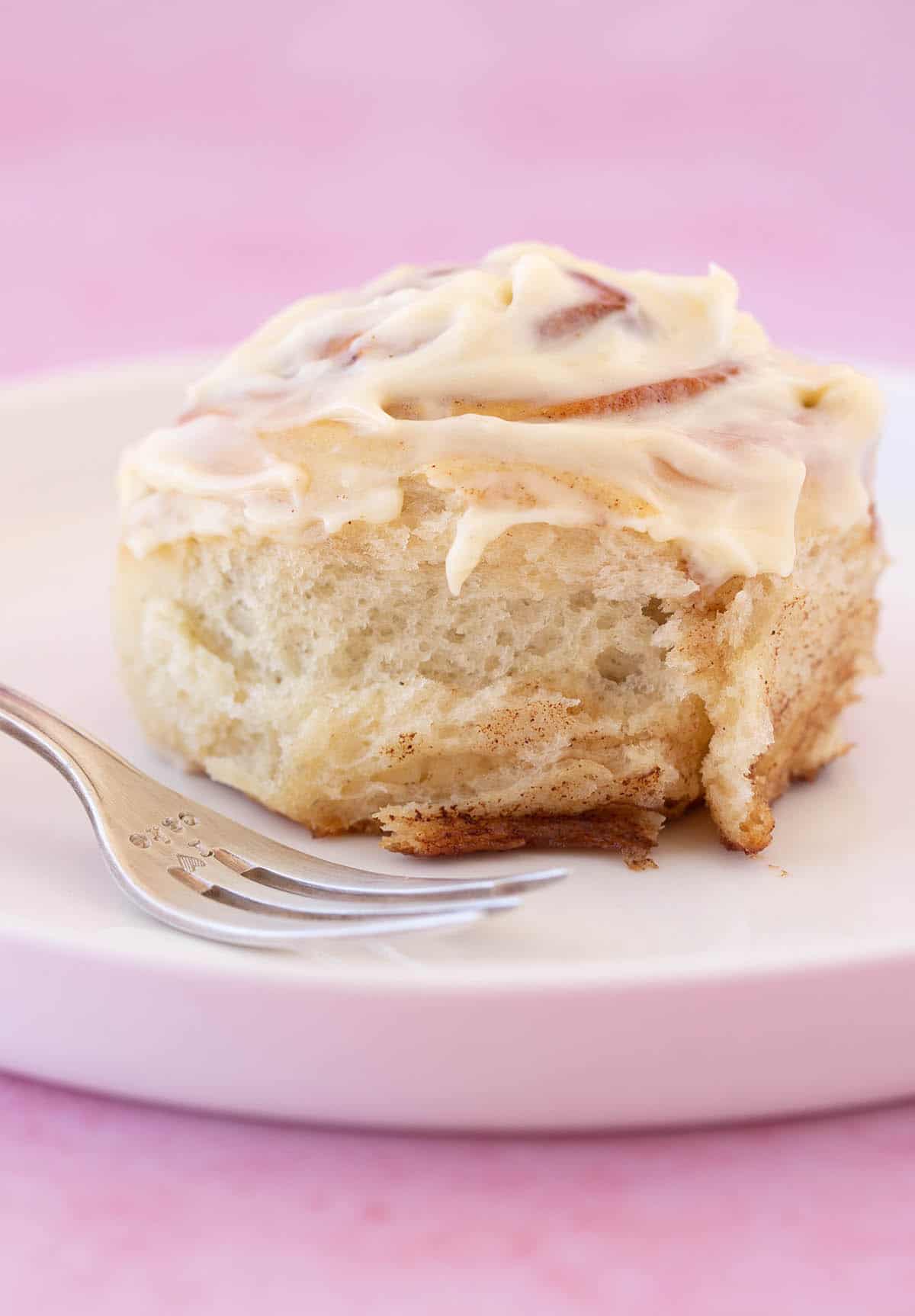 Close up of a homemade Cinnamon Roll covered in cream cheese icing