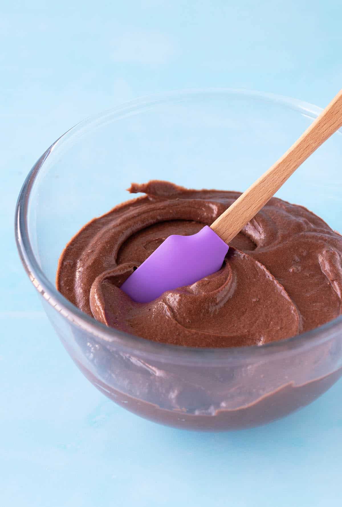 A glass bowl filled with silky smooth chocolate cake batter