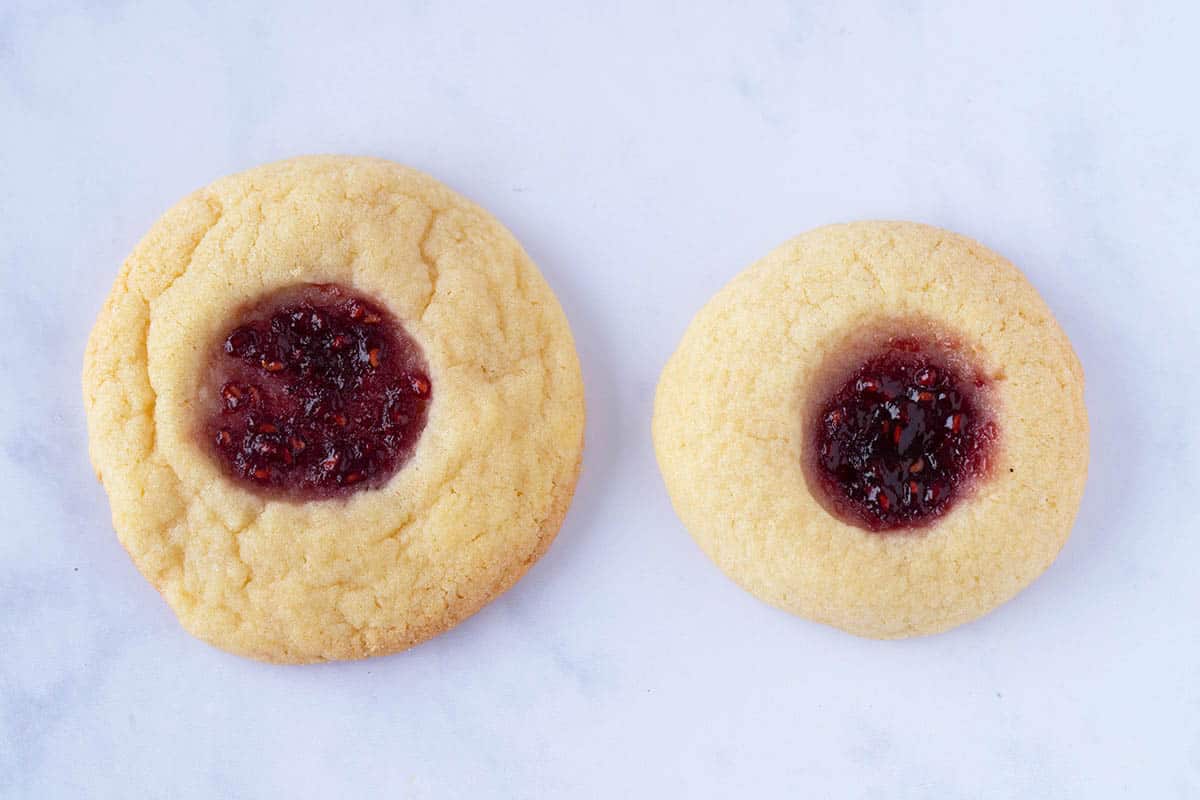 Two thumbprint cookies sitting side by side