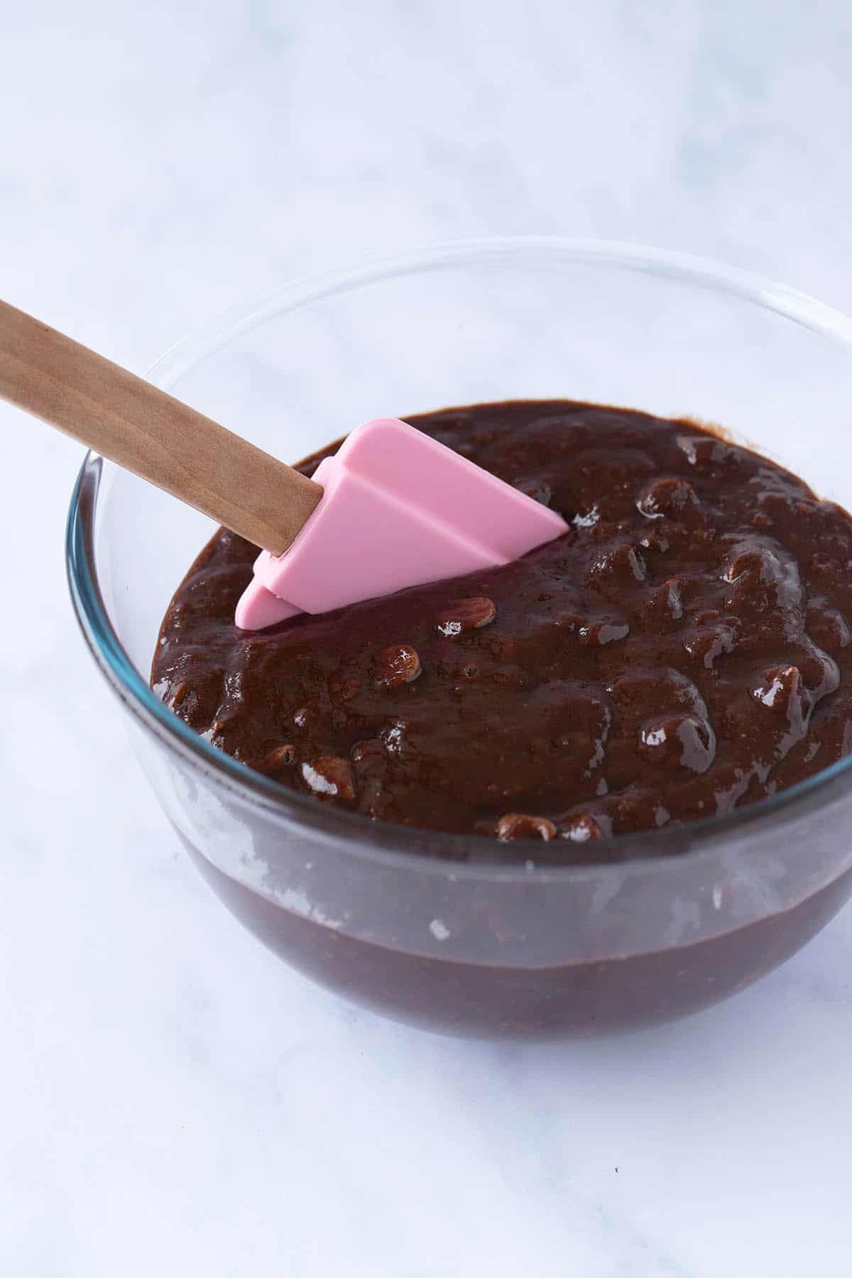 A glass bowl of brownie batter 