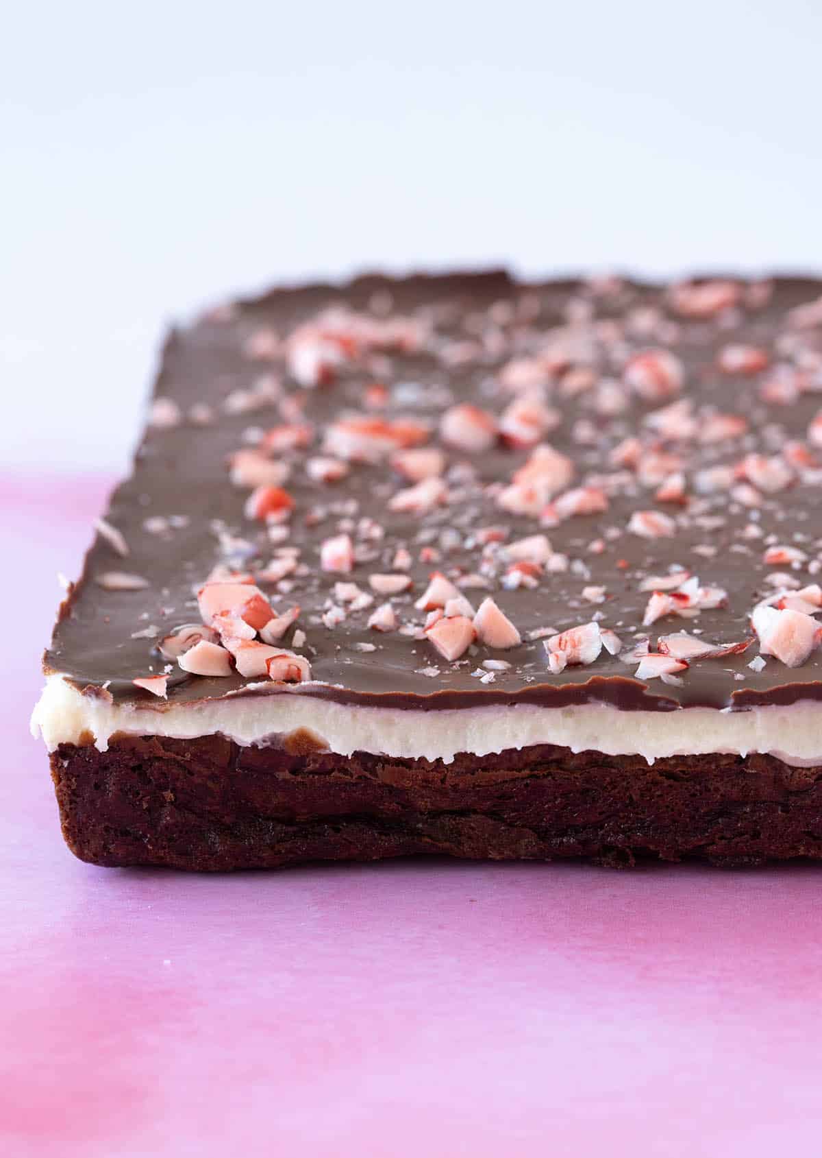 A slab of Peppermint brownie on a pink background 