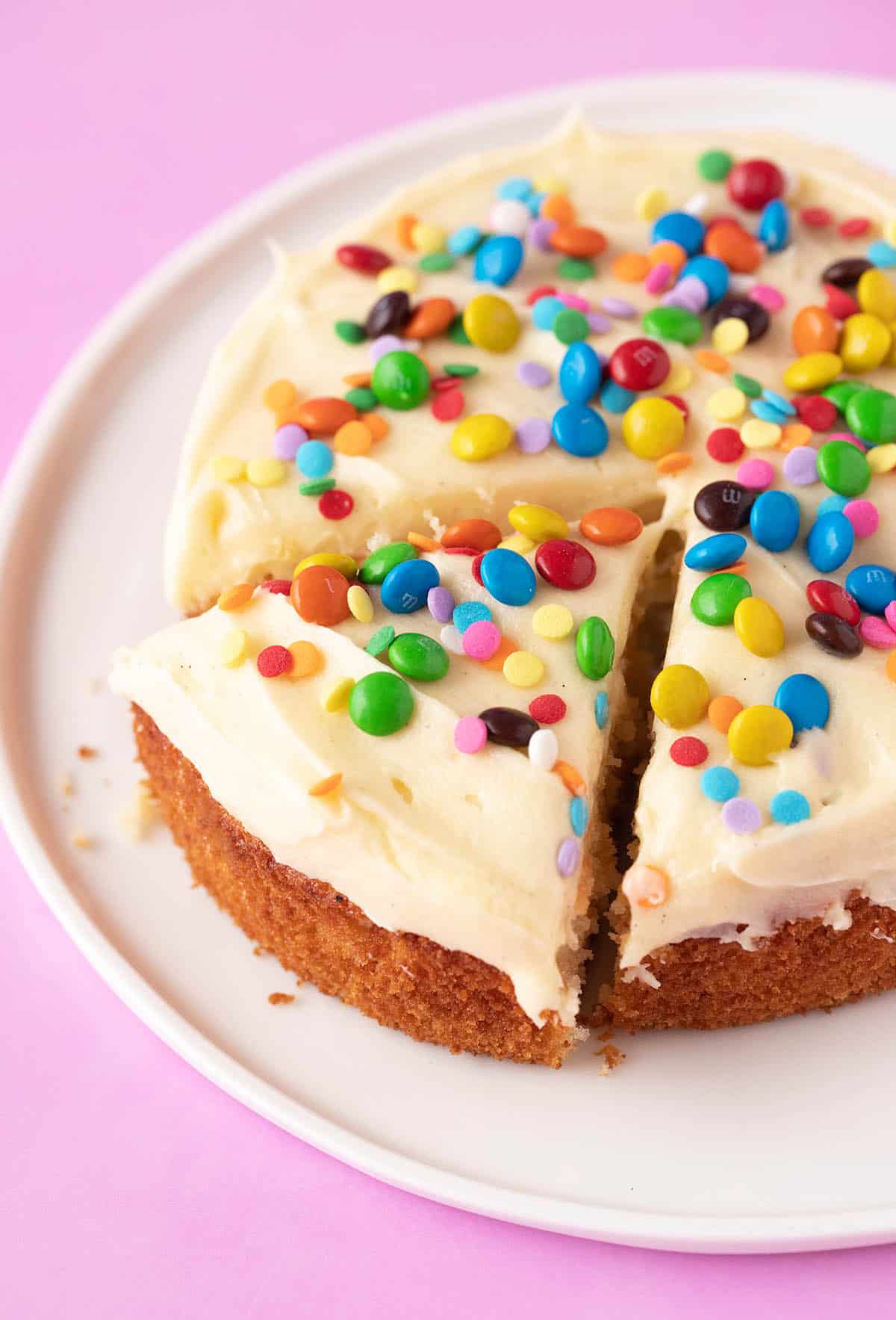 A beautiful one layer Small Vanilla Cake decorated with mini M&M's and sprinkles.