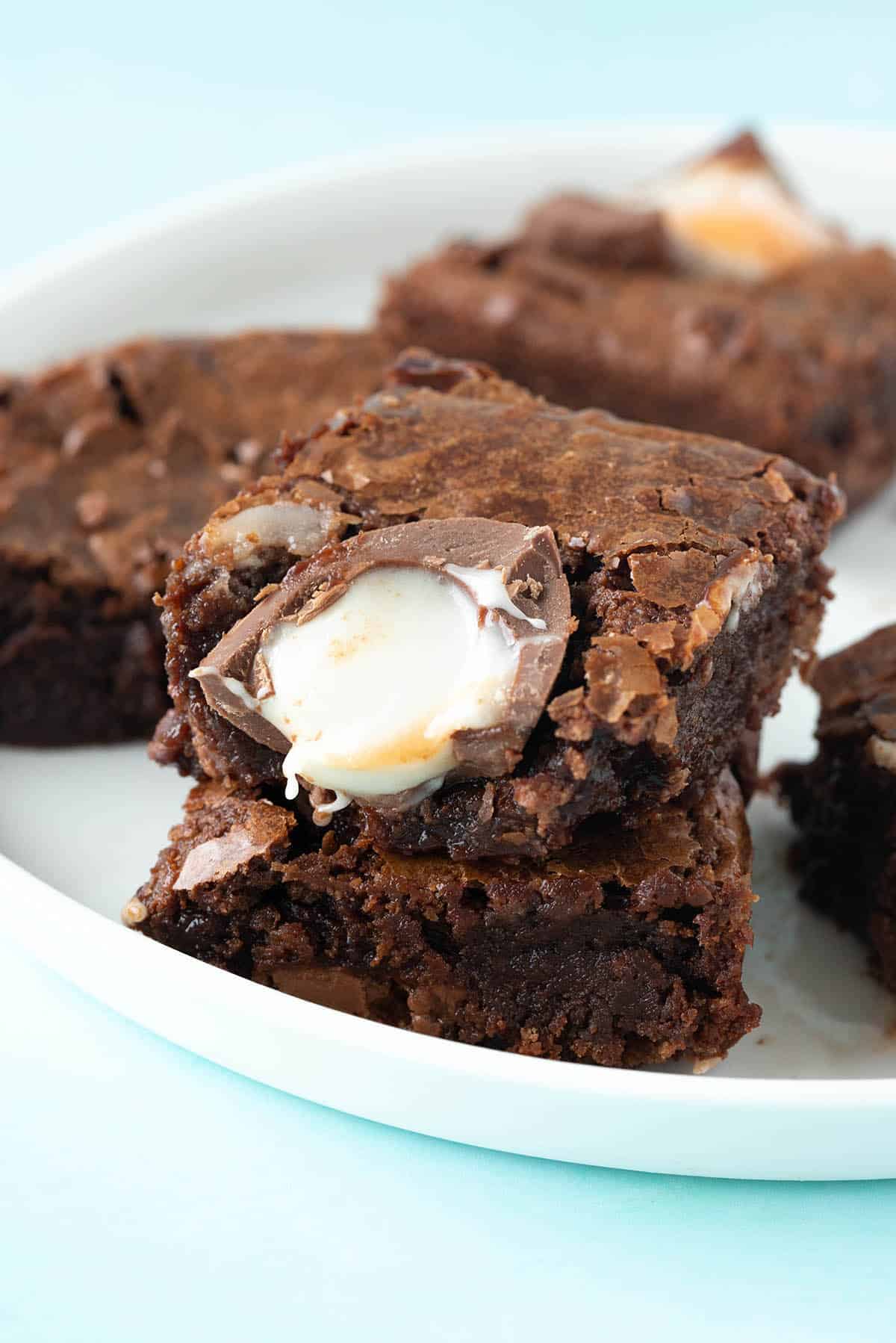 Creme egg brownies on a white plate