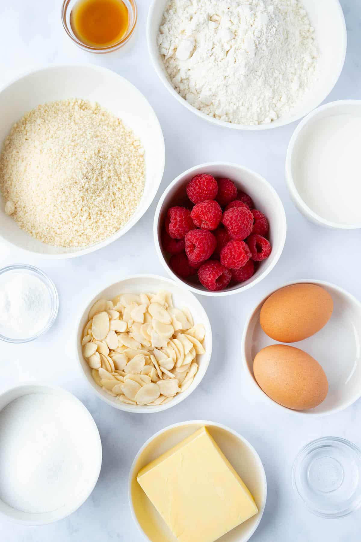 Top view of all the ingredients needed to make a Raspberry Almond Cake from scratch. 