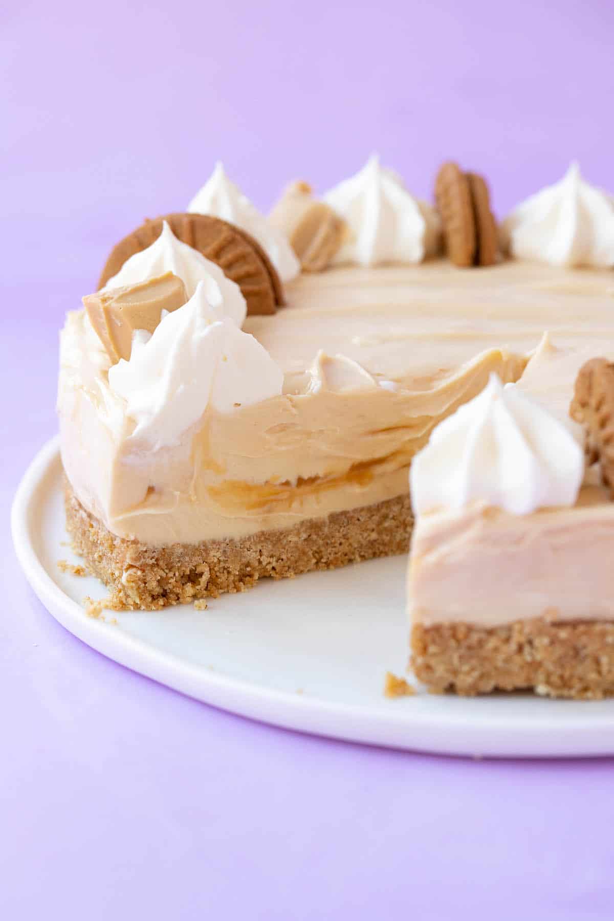 A homemade Caramel Cheesecake with a slice taken out of it. 