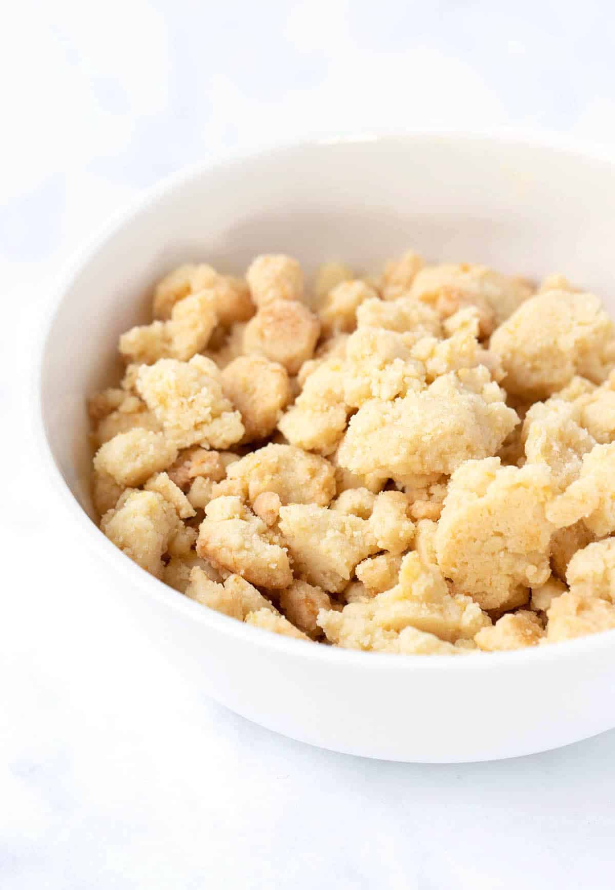 Homemade crunchy cookie crumbs in a white bowl. 