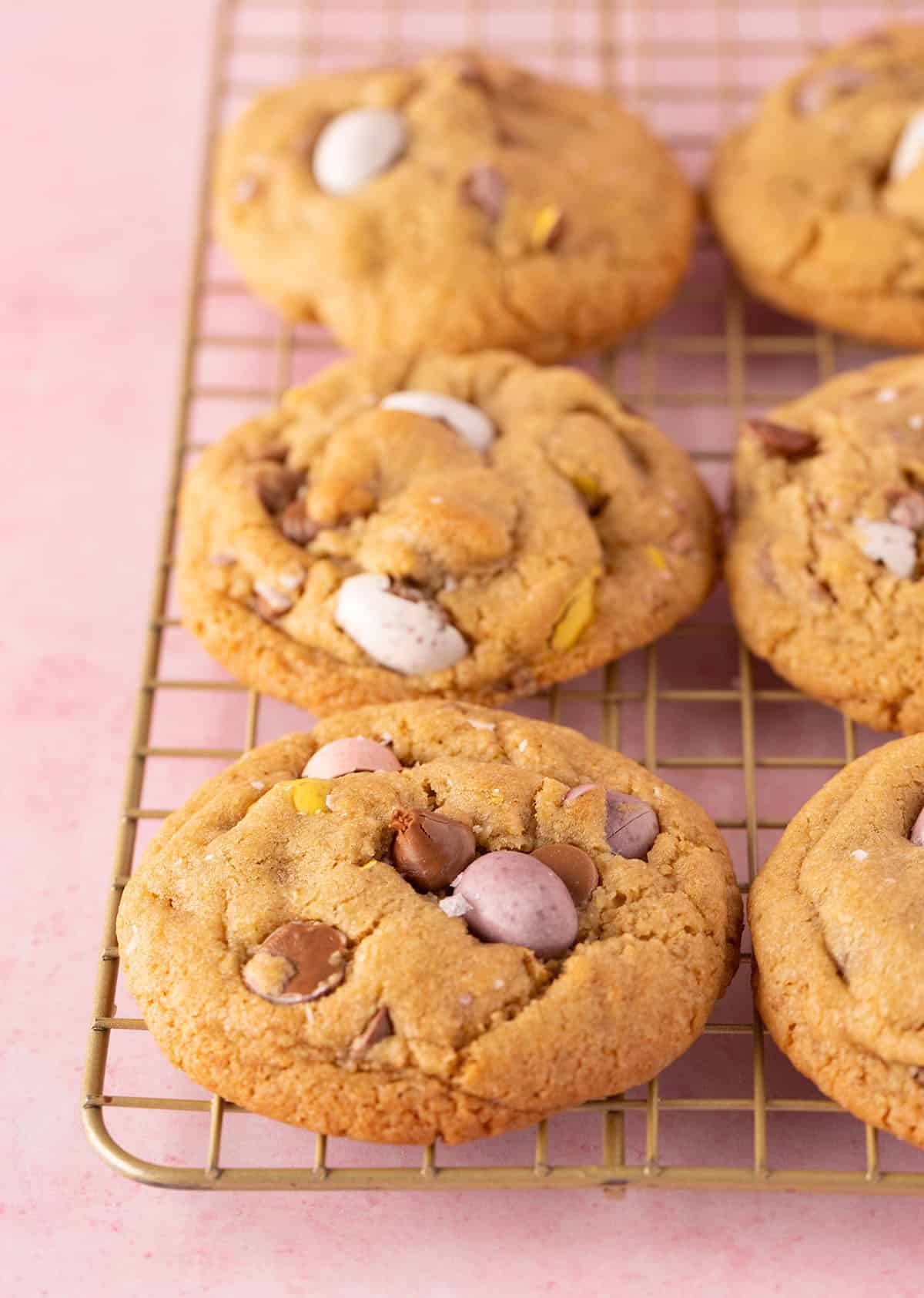 Beautiful Mini Egg Cookies on a gold wire rack cooling. 