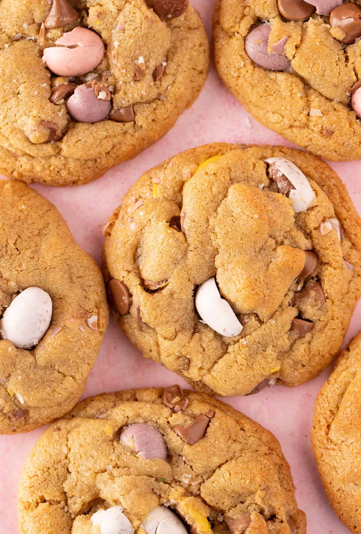 Close up of homemade Mini Egg Cookies on a pink background. 