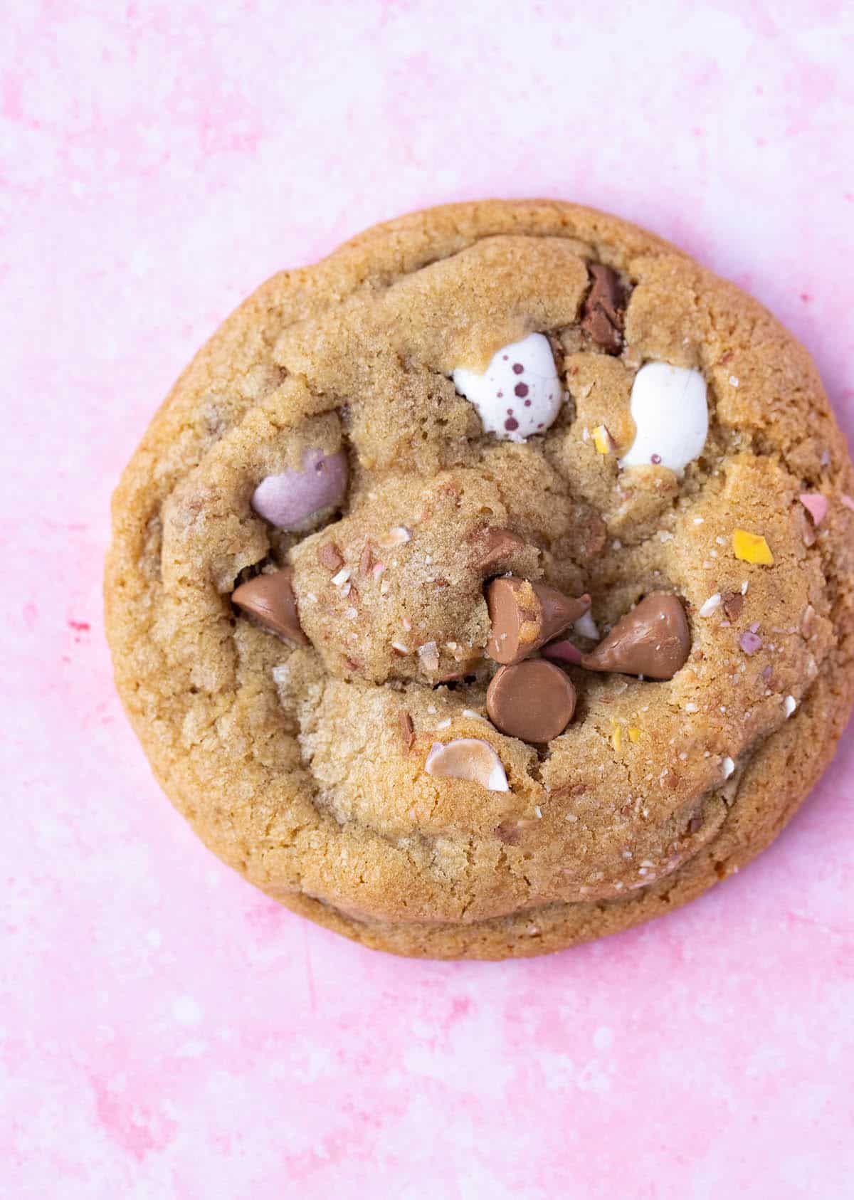 Top view of Mini Egg Cookie sitting on a pink background.