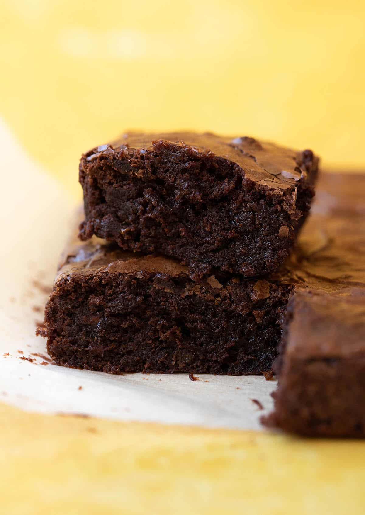 A slice of Chocolate Orange Brownies showing a fudgy middle.
