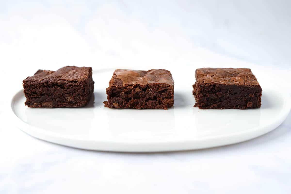 Side view of recipe testing process showing three different homemade brownies.