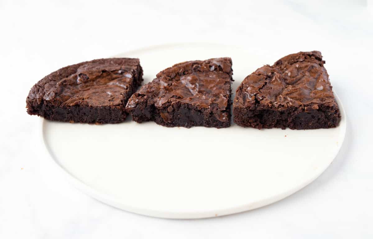 Three pieces of brownie showing the difference in height and texture.
