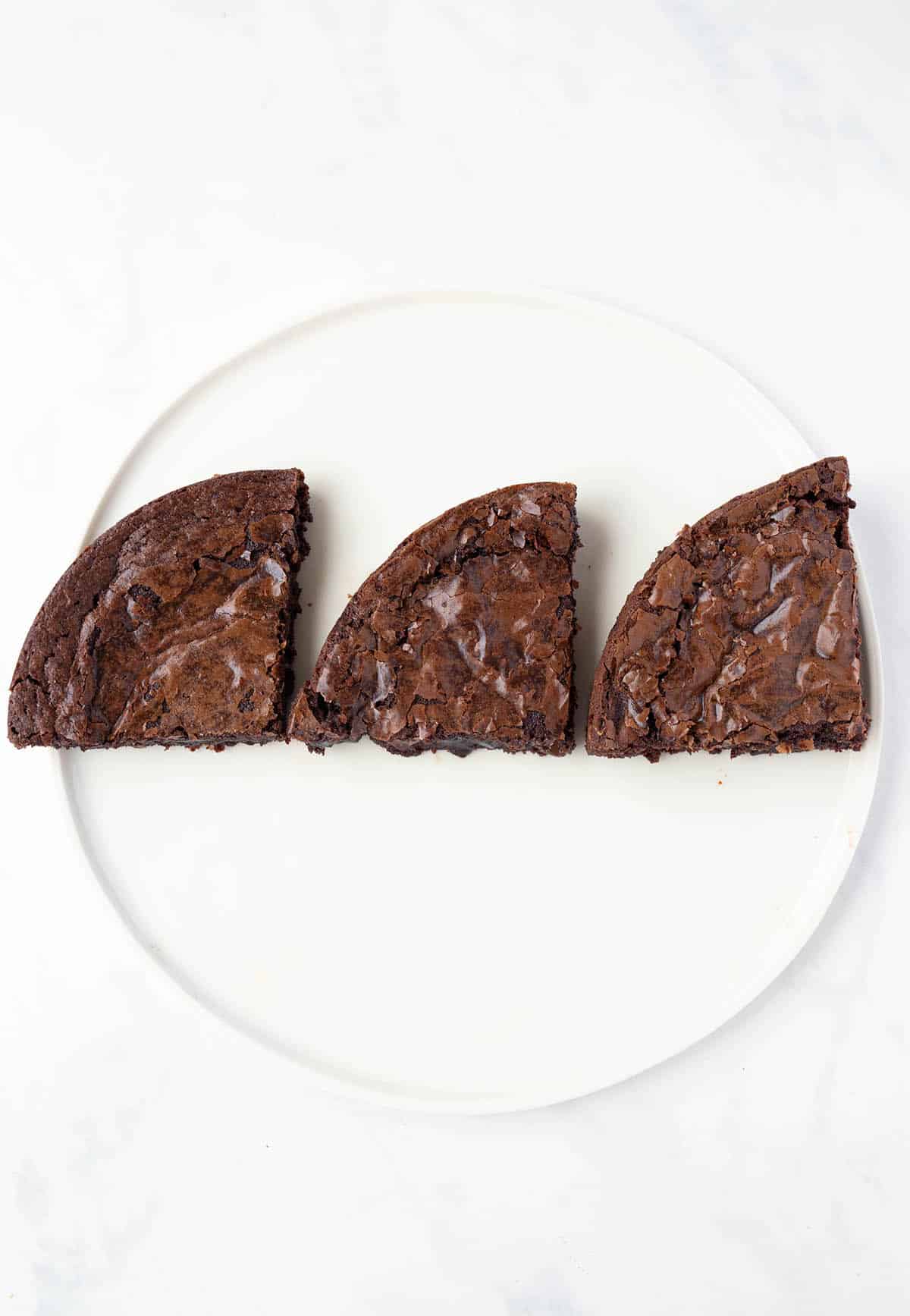 Three different brownies on a plate, side by site comparision.