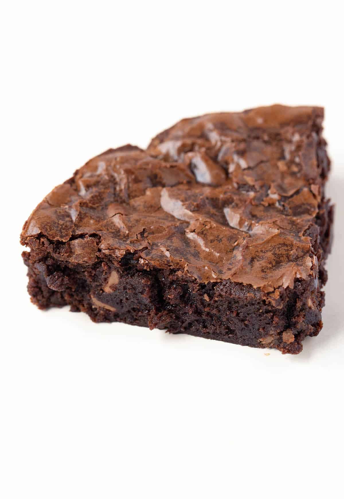 Close up of a homemade fudgy brownie with a gooey middle.