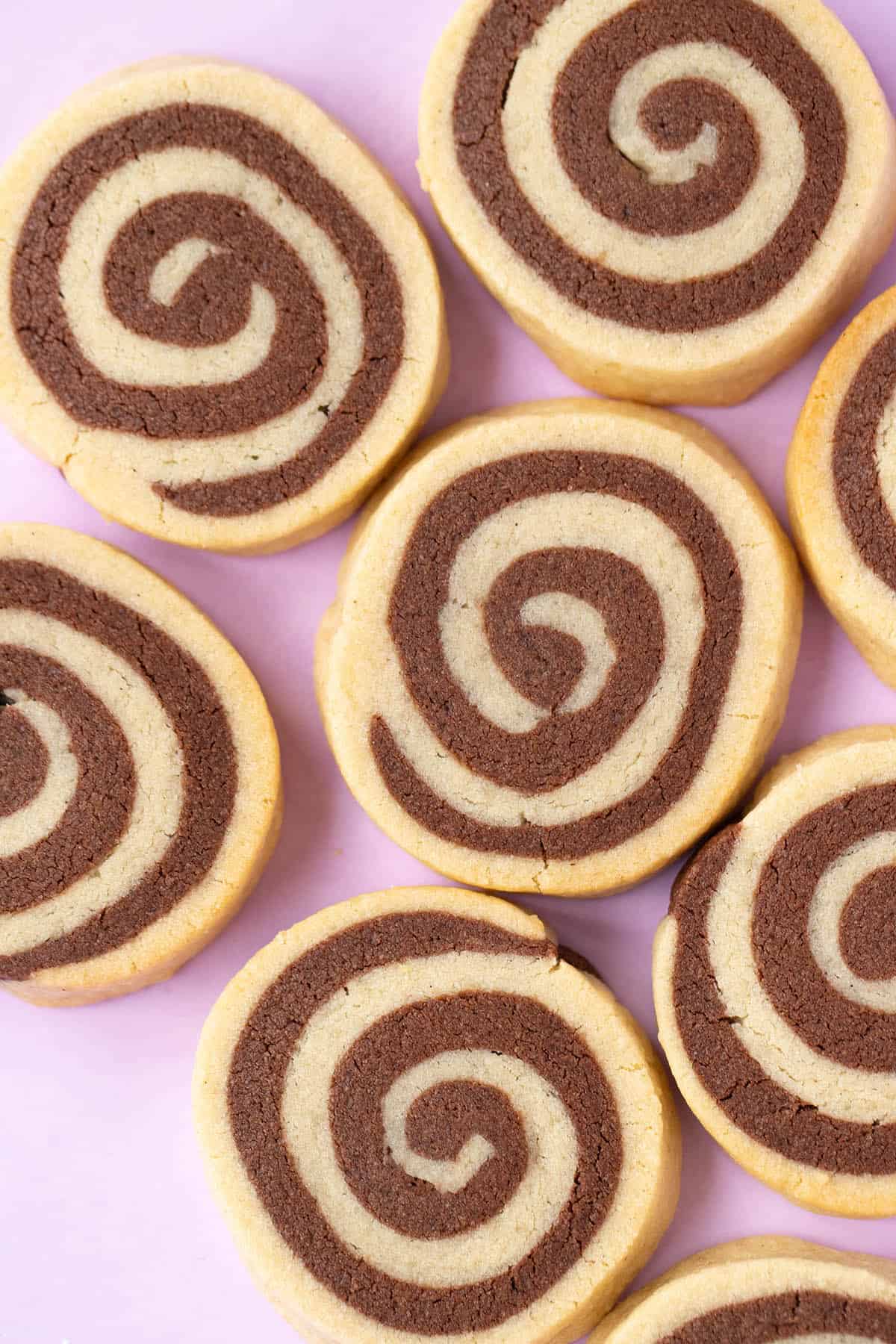 Top view of perfectly swirled Pinwheel Cookies on a purple background.