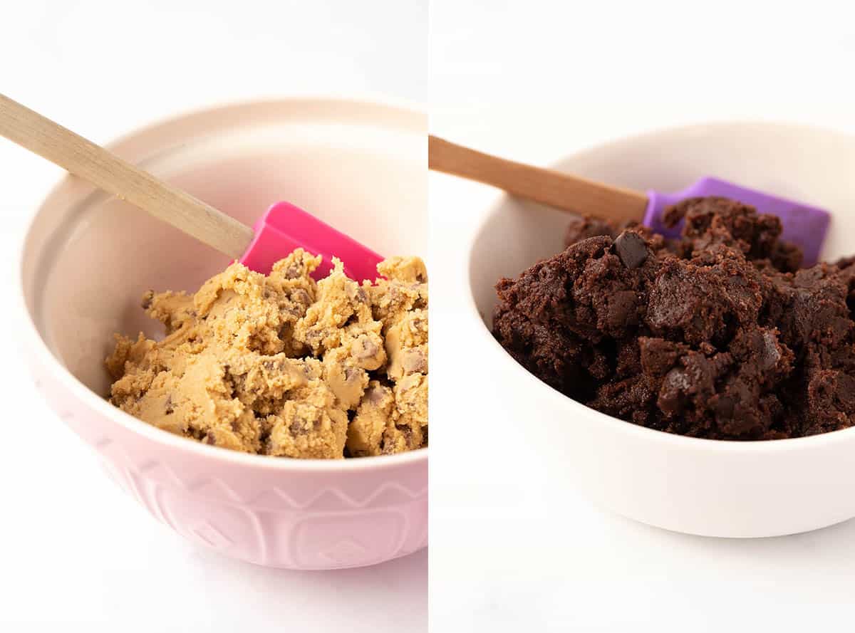 Two bowls of cookie dough, chocolate chip and brownie on a white background. 