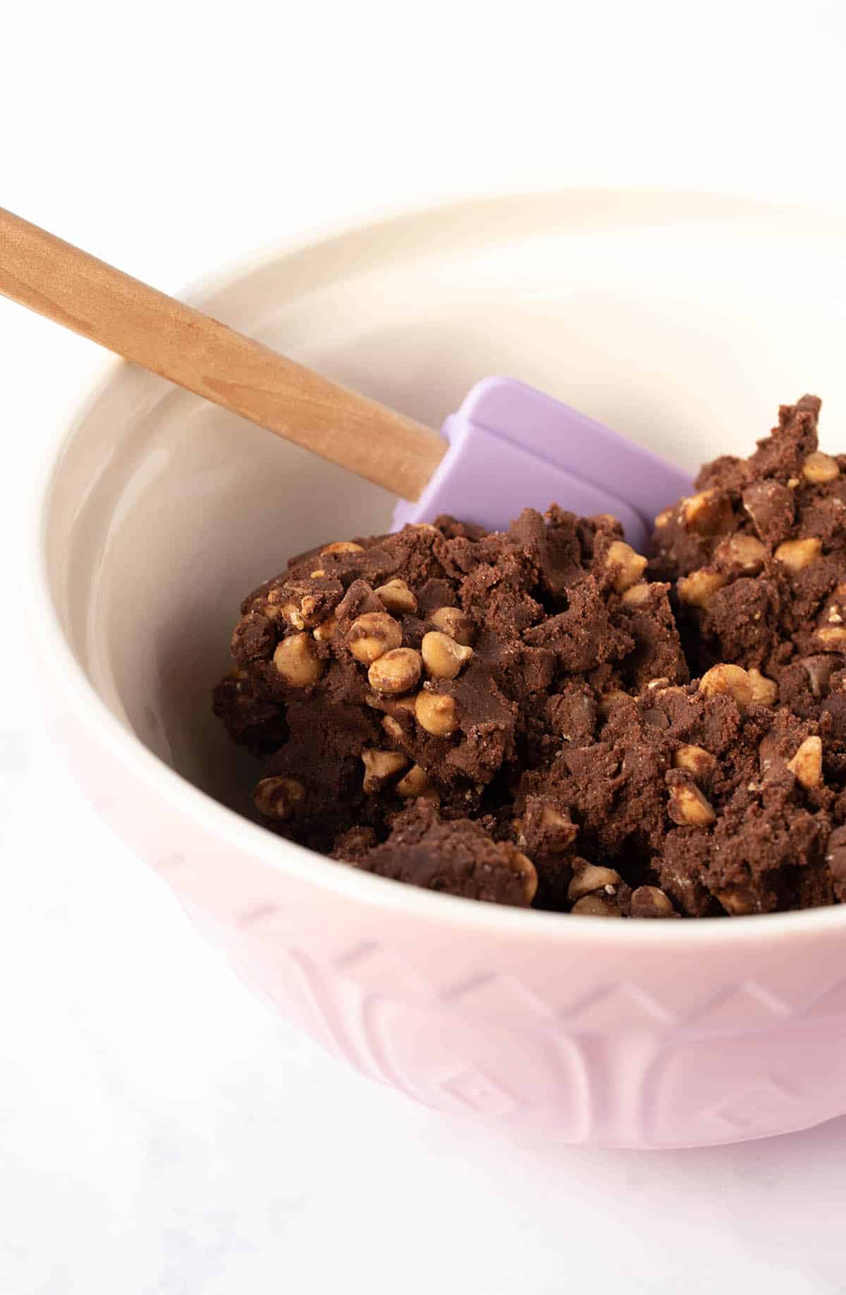 A large mixing bowl filled with chocolate cookie dough. 