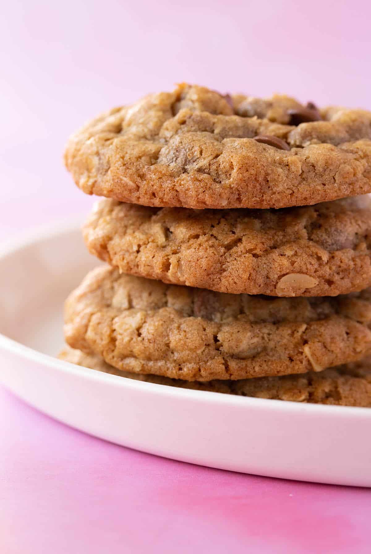 A stack of thick Oatmeal Cookies on a white plate.