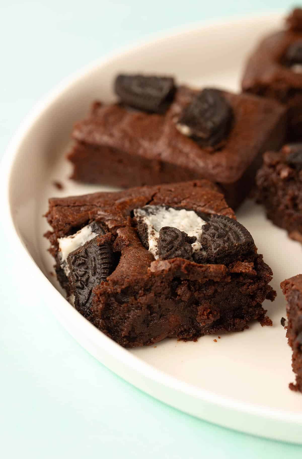 A white plate filled with Oreo Brownies.