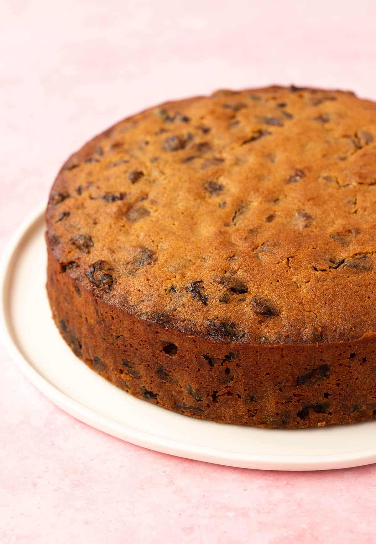 Homemade Fruit Cake sitting on a white plate. 