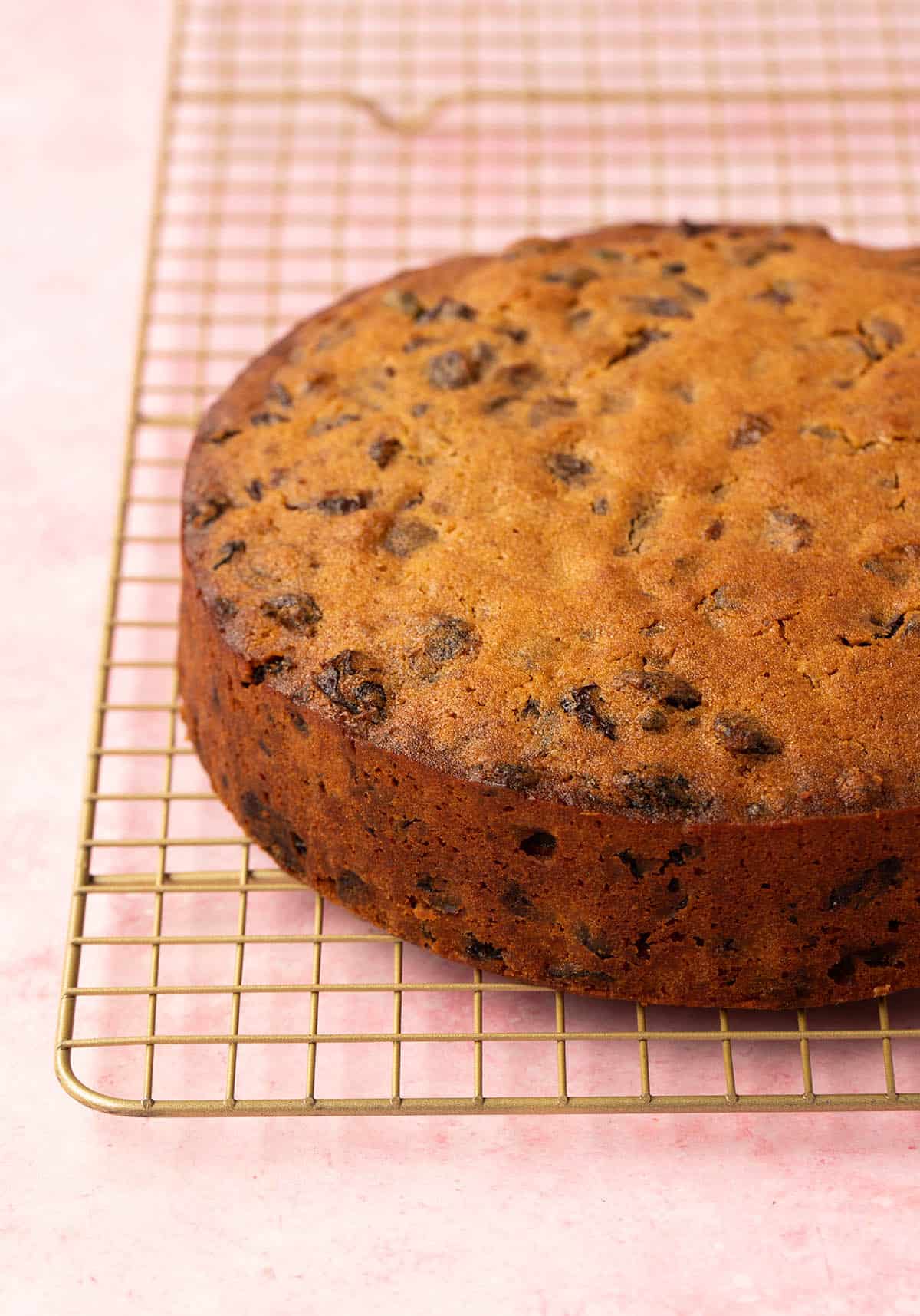 A finished Fruit Cake cooling on a wire rack. 
