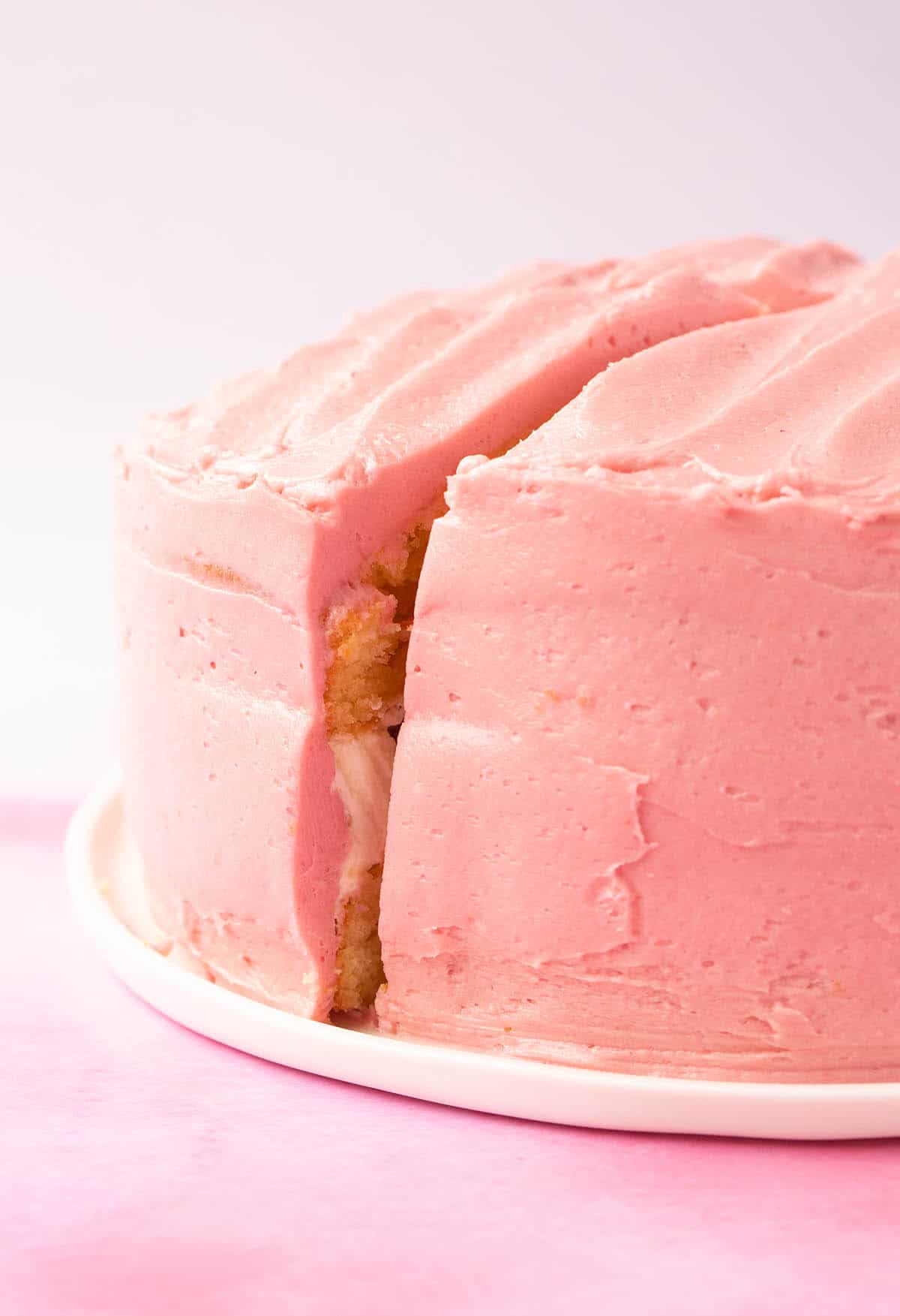 Close up of a beautiful Lemon Raspberry Cake frosted with pink buttercream.