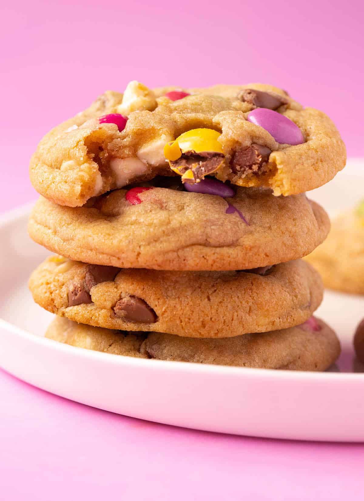 A stack of homemade Smartie Cookies on a white plate. 