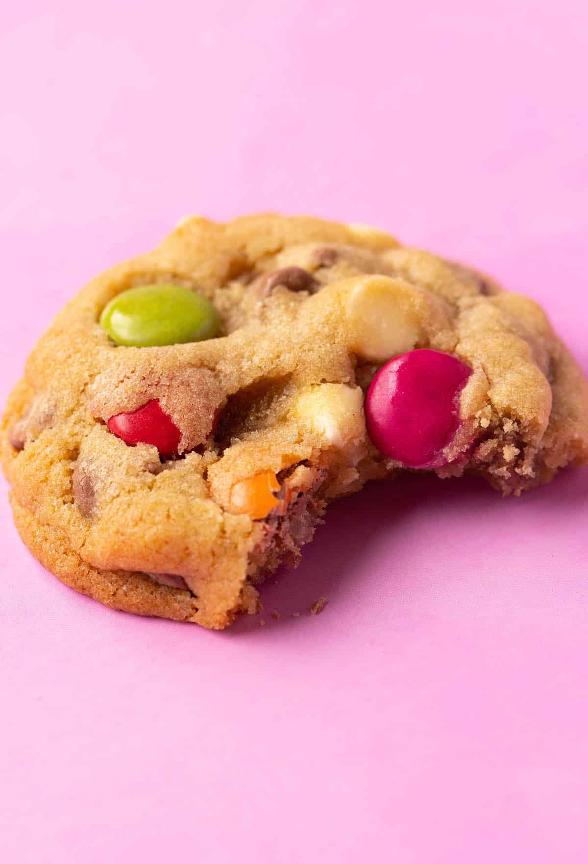 A Smartie Cookie with a bite taken out of it. 