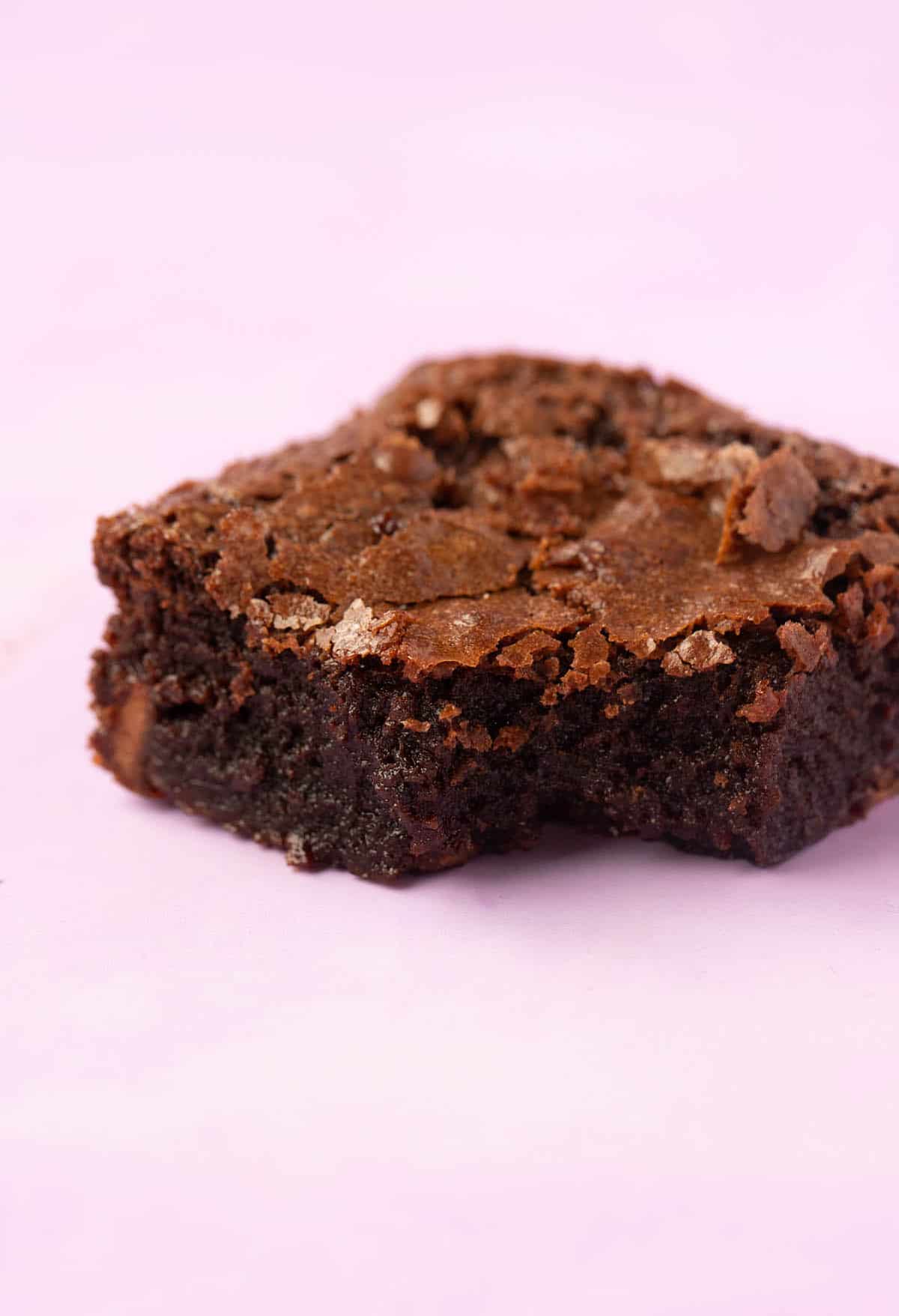 Close up of a Gluten Free Brownie with a bite taken out of it.