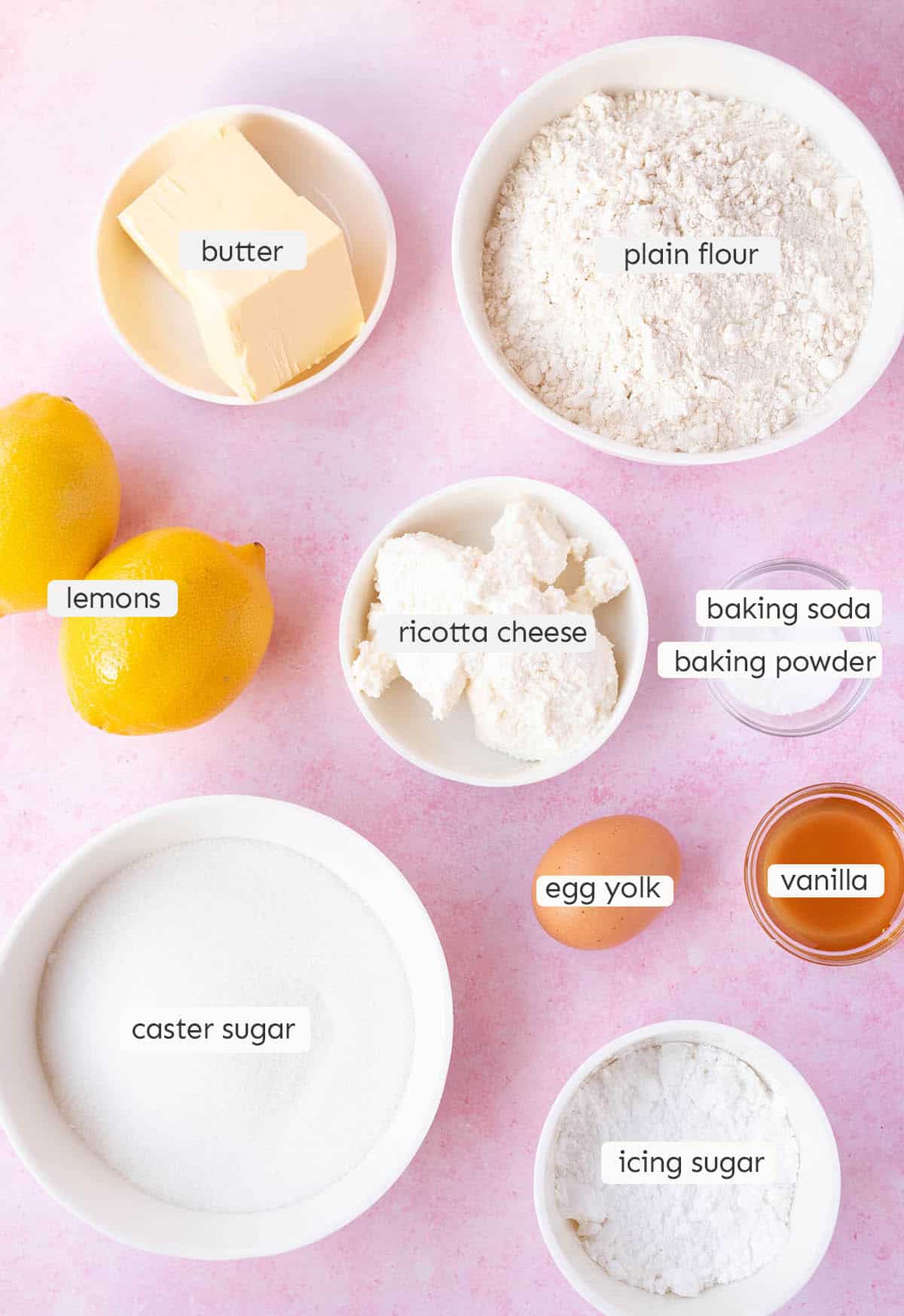 All the ingredients needed to make Lemon Ricotta Cookies from scratch on a pink background.