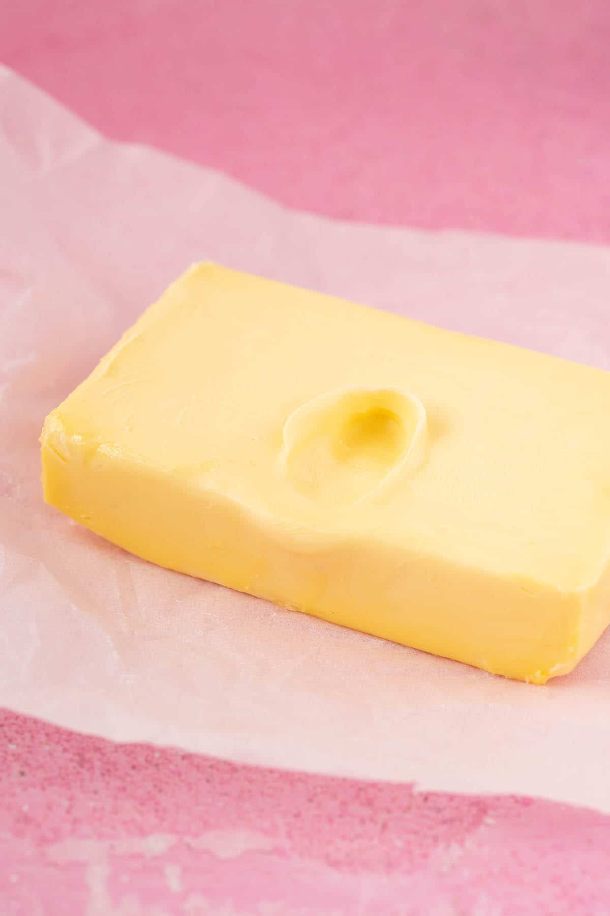 A block of butter with a thumb imprint. 