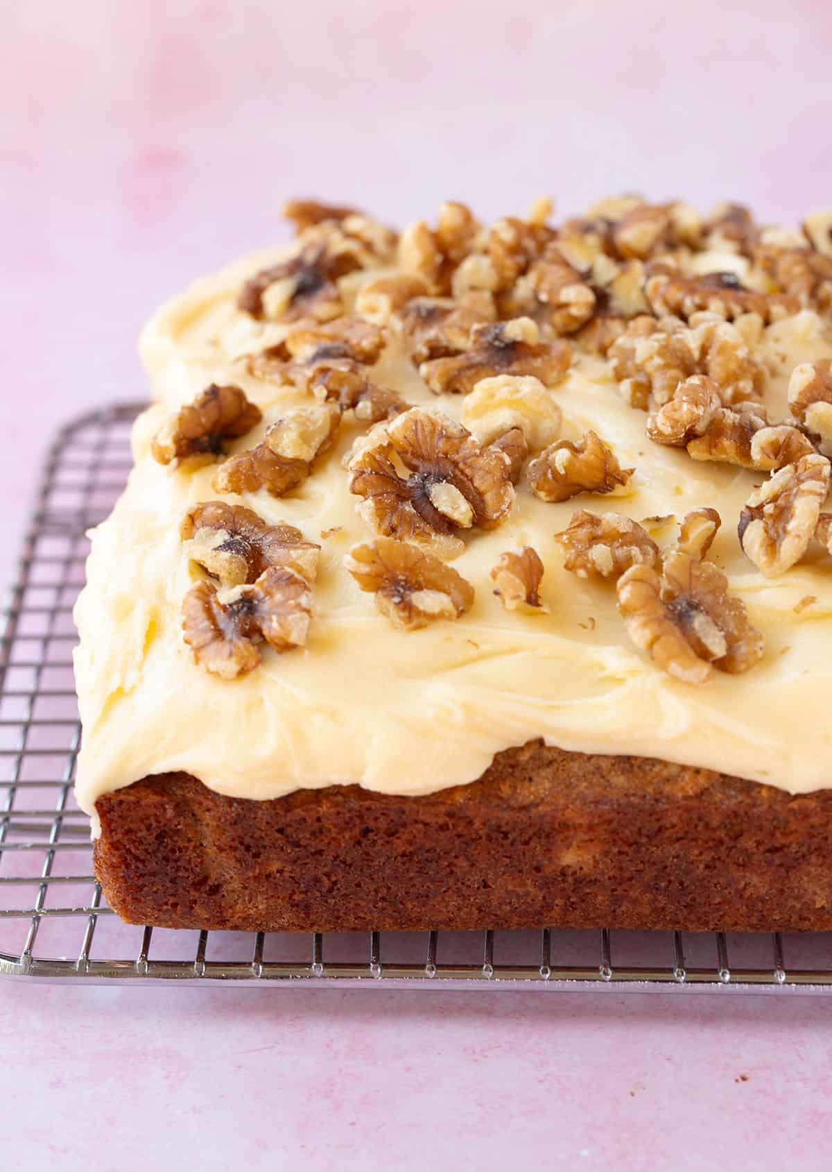Banana Snack Cake topped with cream cheese frosting and walnuts. 