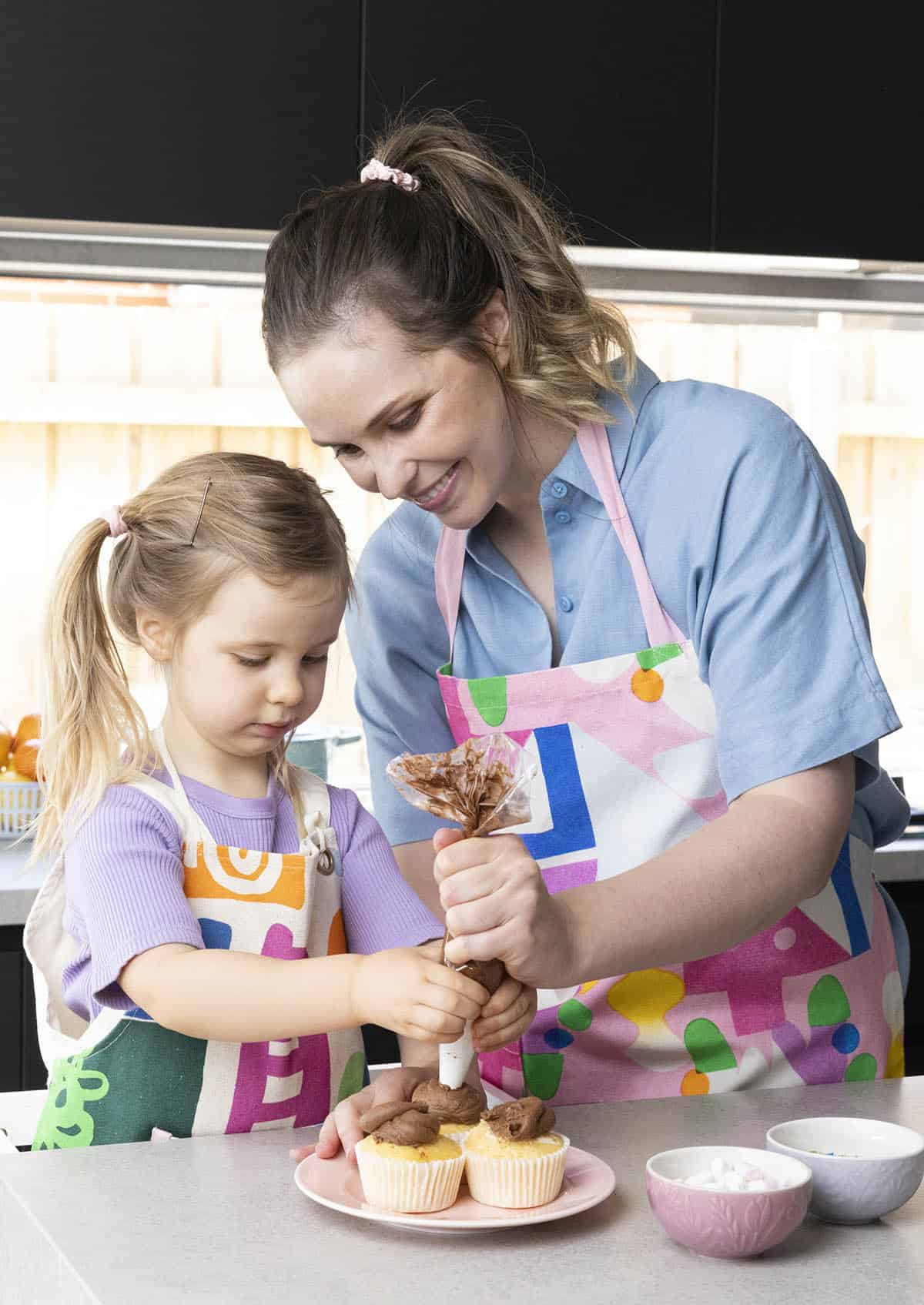 Jessica Holmes baking with her daughter in the kitchen.