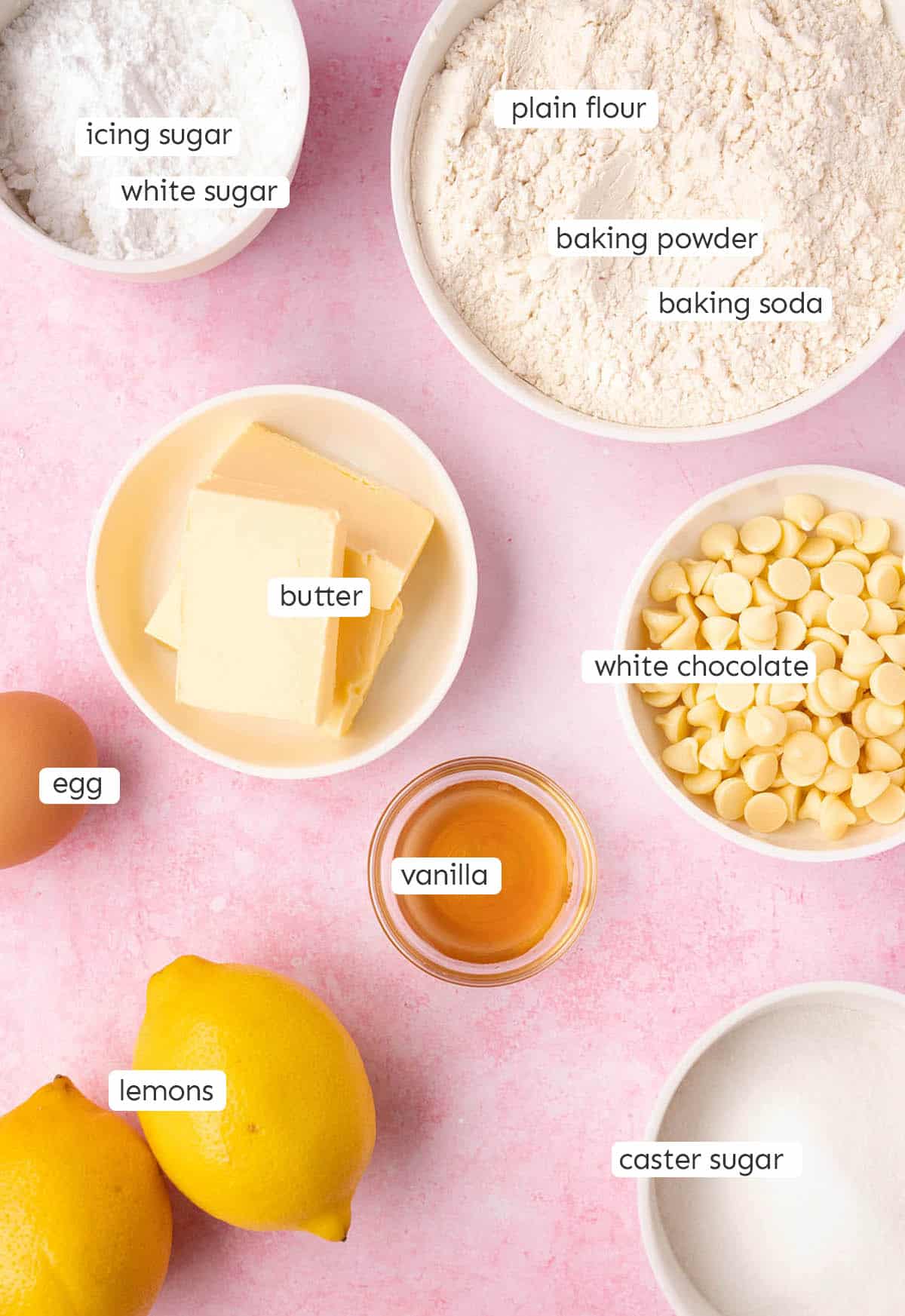 All the ingredients needed to make Lemon Crinkle Cookies from scratch on a pink backdrop.
