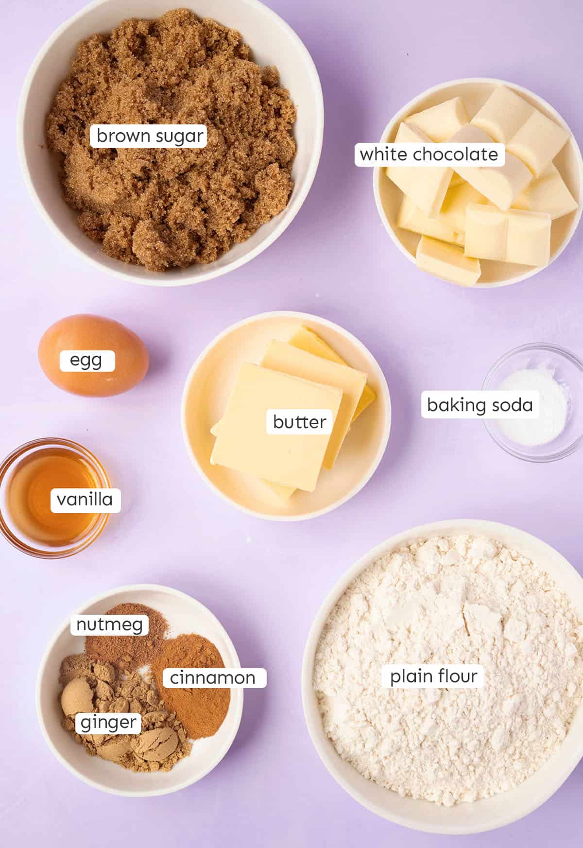 All the ingredients needed to make Gingerbread NYC Cookies from scratch on a purple background. 