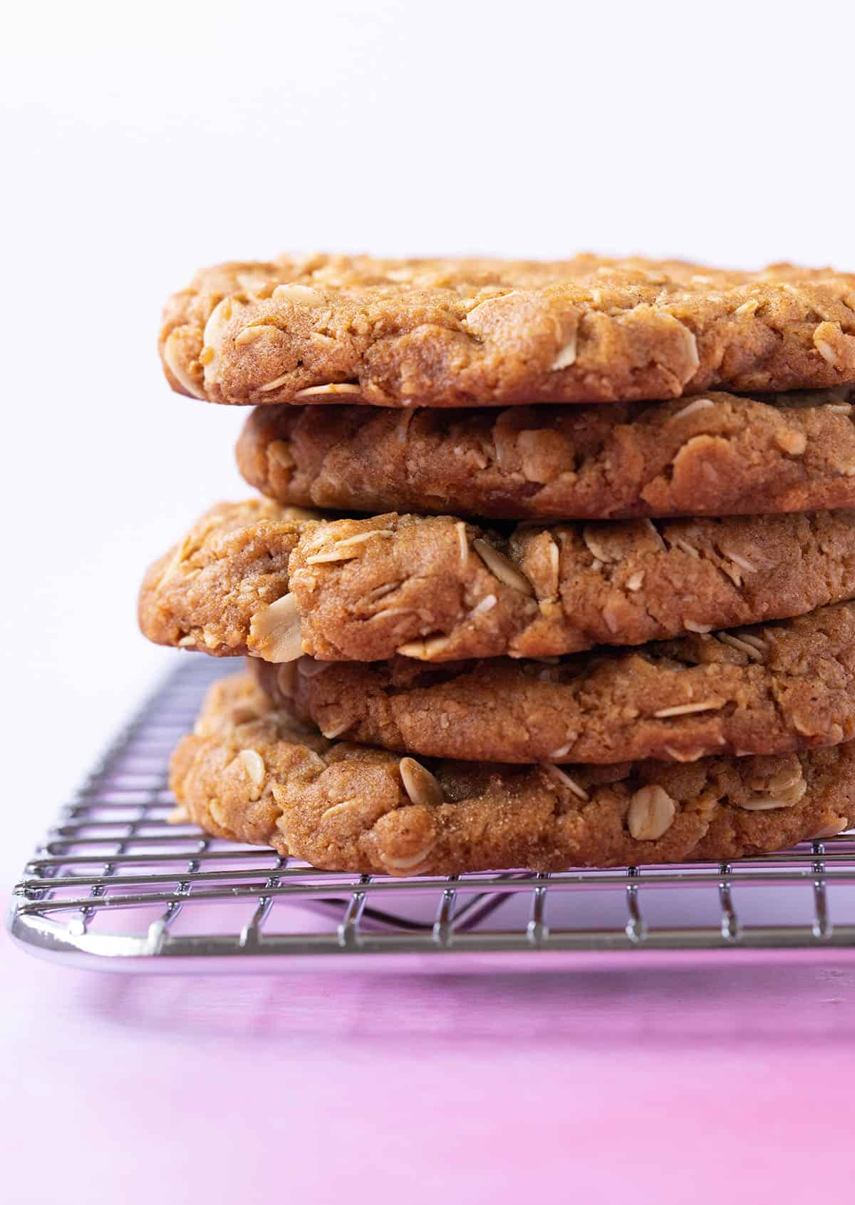 A stack of homemade Anzac Biscuits with crispy edges. 