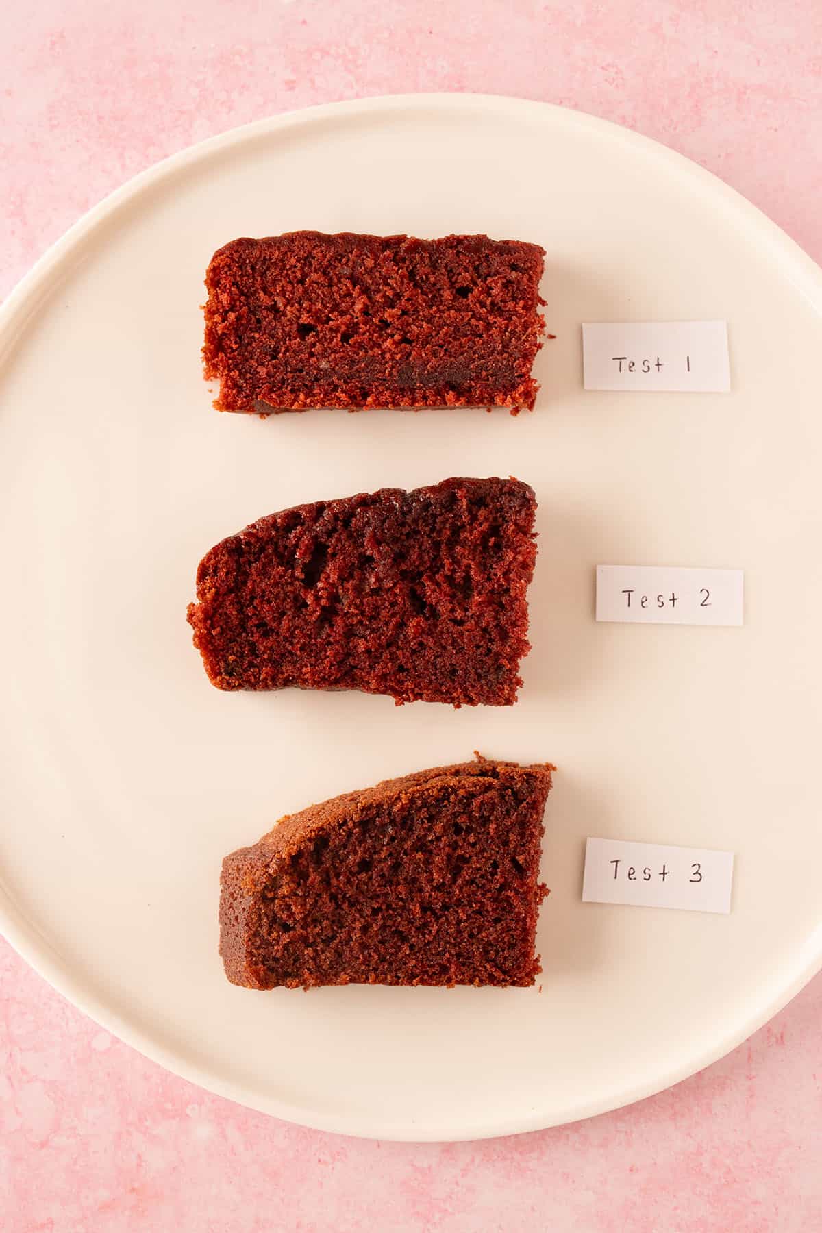 Three different slices of red velvet cake showing the recipe testing process.