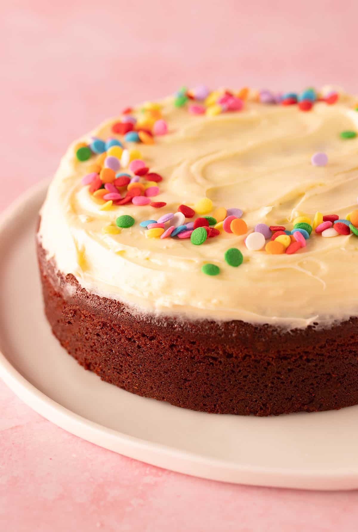 A mini Red Velvet Cake decorated with sprinkles.