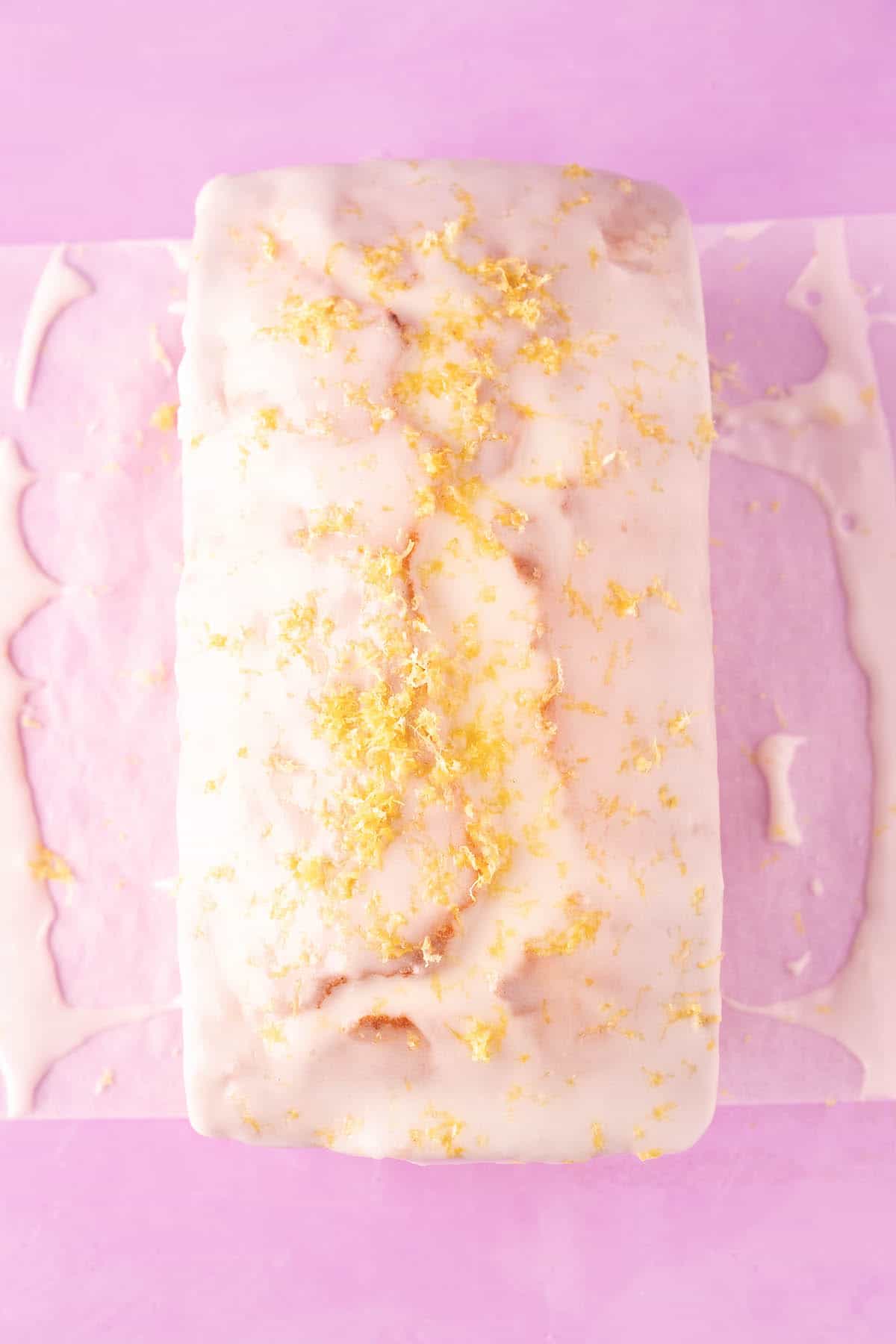 Top view of a dripped Lemon Pound Cake topped with fresh lemon zest. 