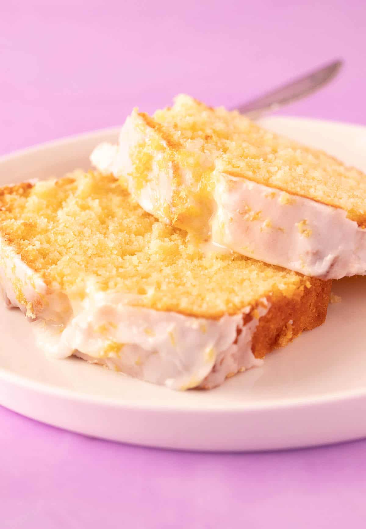 Two gorgeous pieces of Lemon Pound Cake on a white plate. 