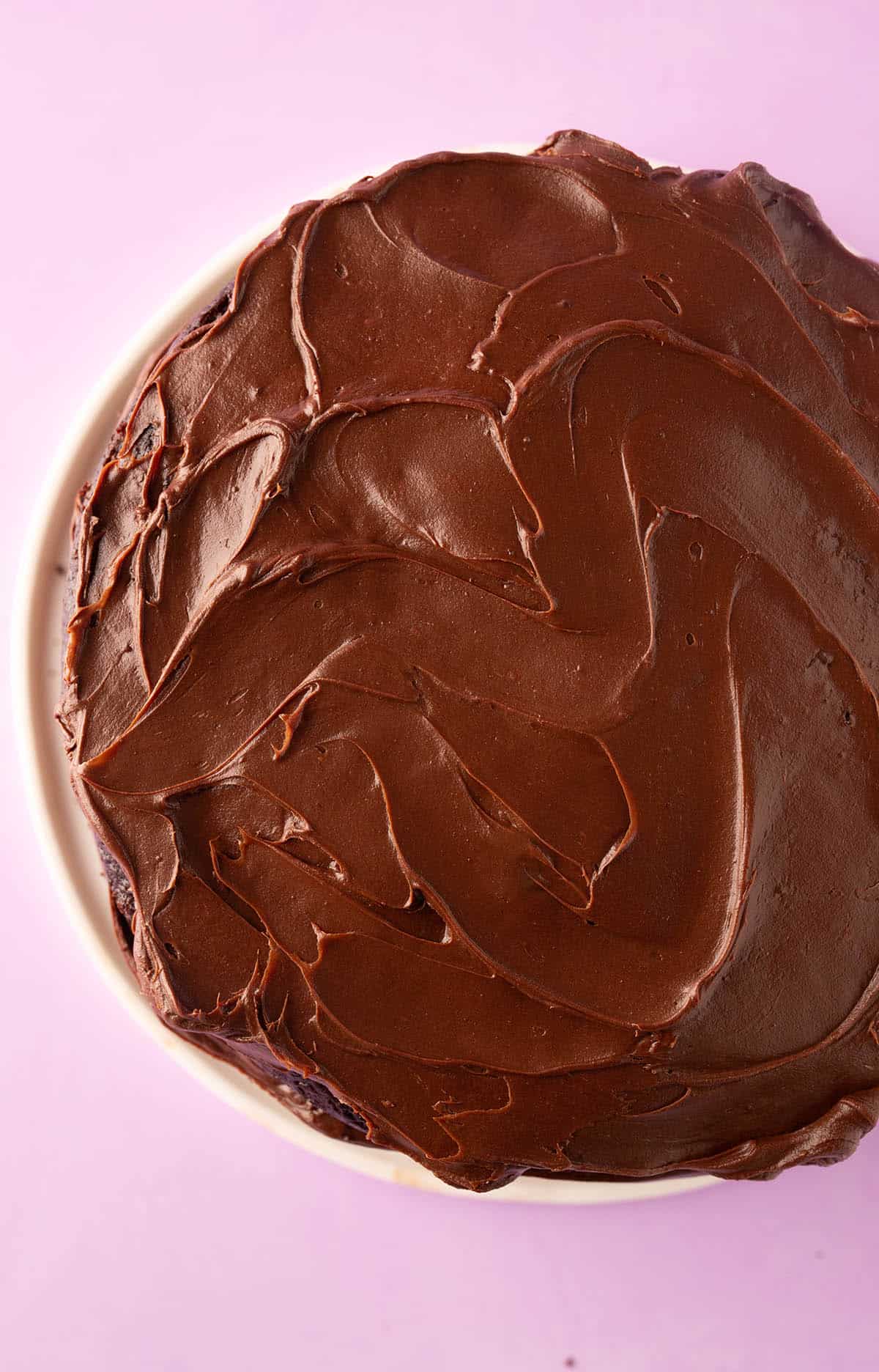Top view of a cake decorated with homemade chocolate ganache frosting.
