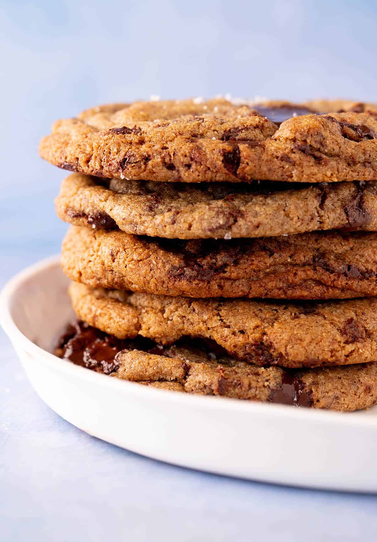 A tall stack of Rye Chocolate Chip Cookies on a white plate.