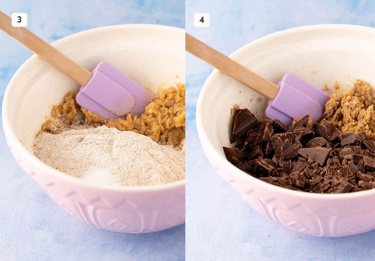 A mixing bowl of cookie dough with chunks of chocolate added.