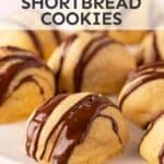 Chocolate stuffed shortbread cookies on a white plate.