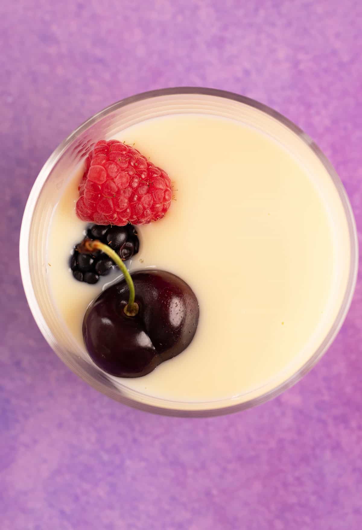 Top view of homemade custard topped with fresh fruit. 