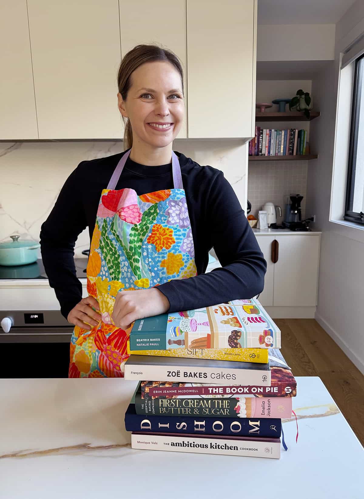 Jessica Holmes from Sweetest Menu in her kitchen smiling.